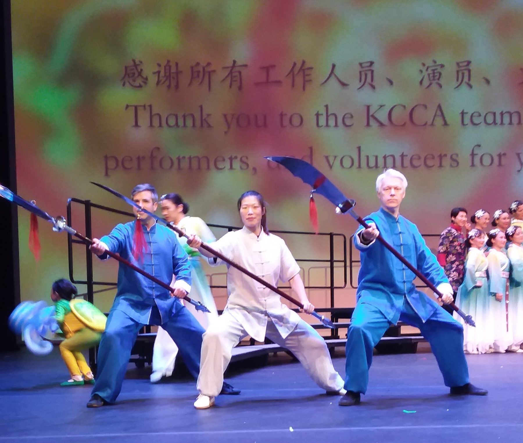 Brandon Stevens, Master Chen Huixian, and Aaron Crim performing traditional weapons on stage