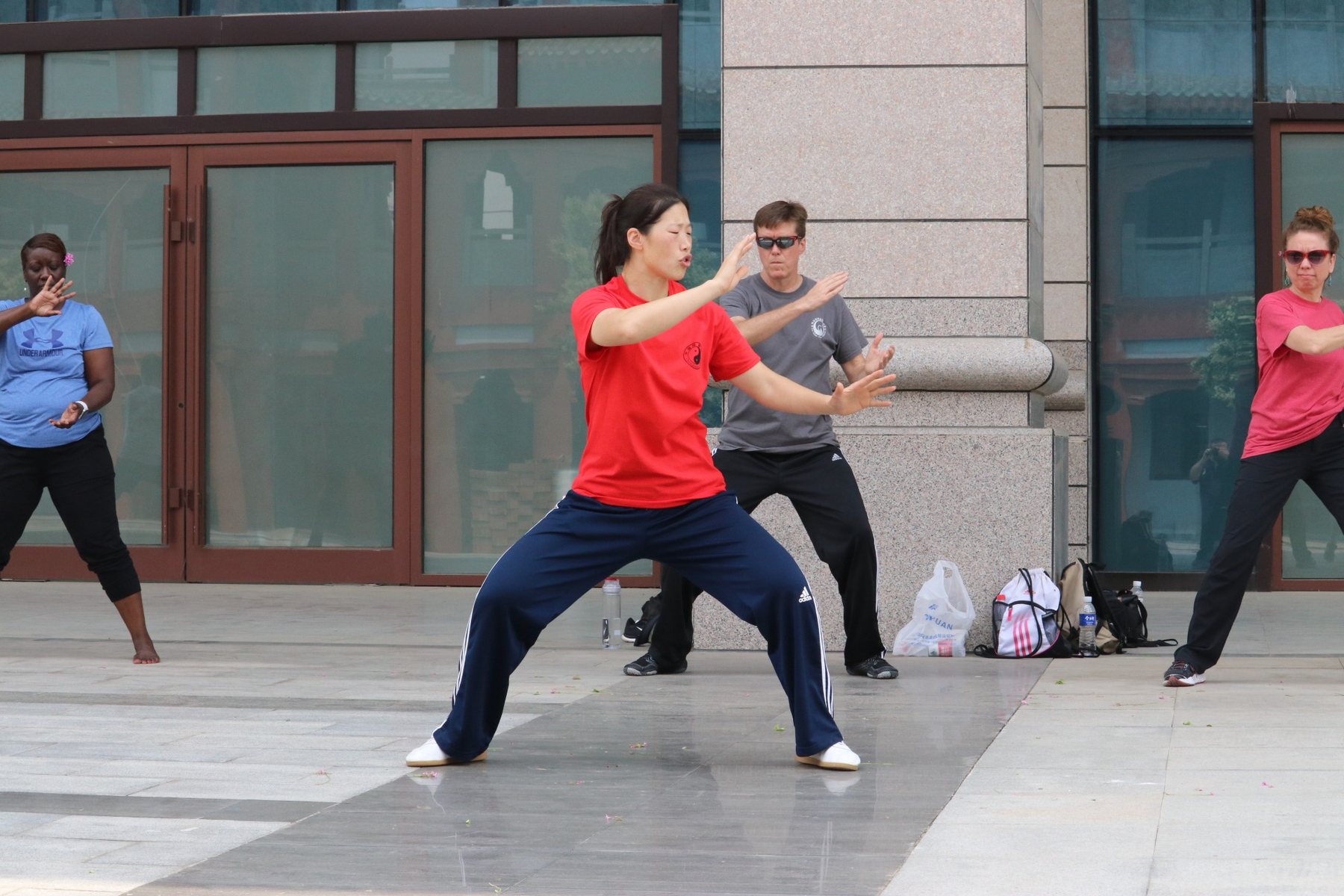 Master Chen Huixian leading students through Chen Taijiquan outdoors in Chenjiagou