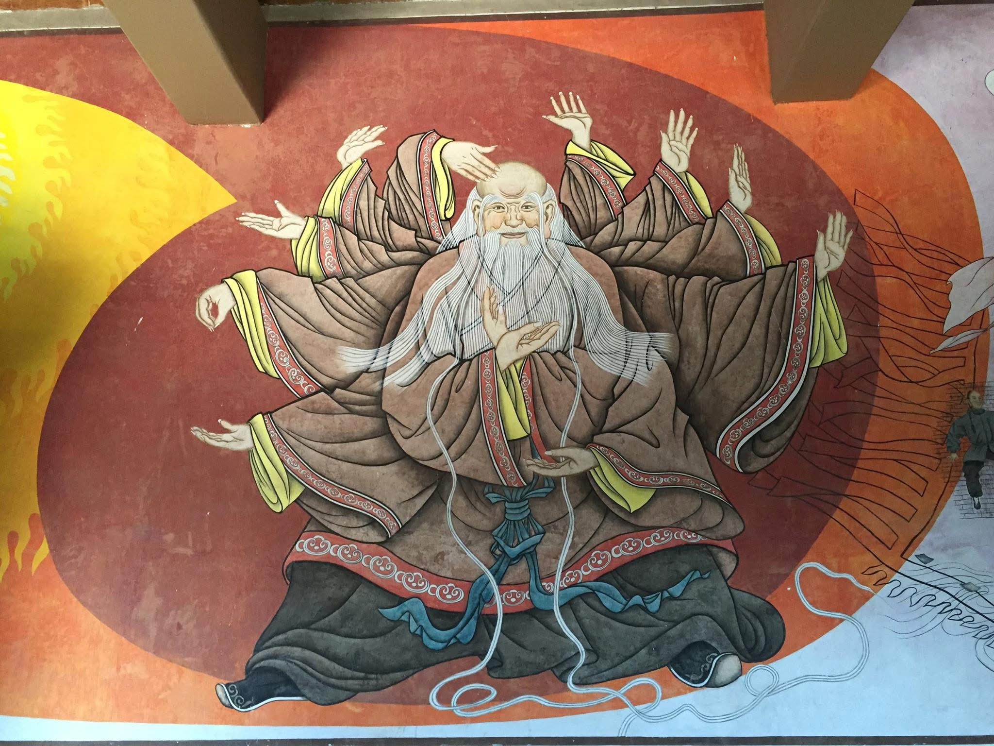 Temple mural of a multi-armed elder representing the many empty-hand forms of Taijiquan