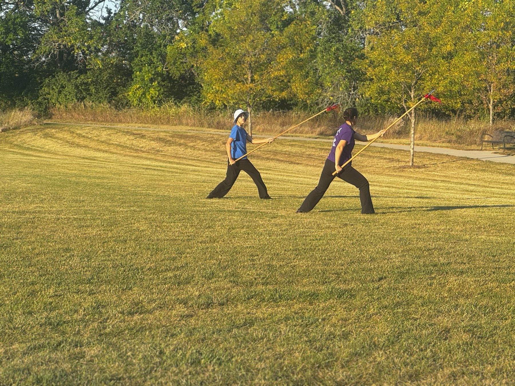 Two students practicing the Chen Taiji spear form outdoors in Kansas City